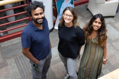 a man in a blue polo, woman in a black shirt, and woman in a green striped dress from above